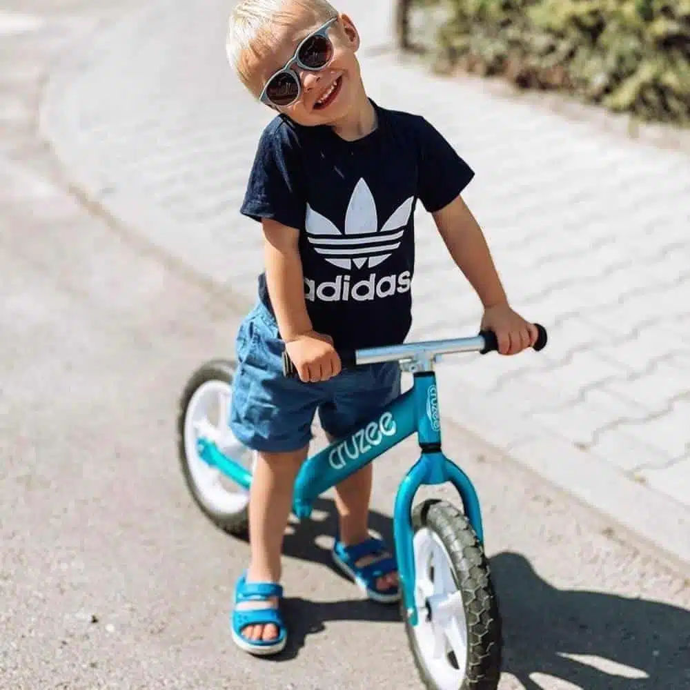 Cruzee 12 Balance Bike Blue Boy with sunglasses on cruzee
