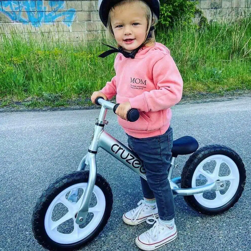 Cruzee 12 Balance Bike in Silver with Girl on Bike Xchange Sports Australia